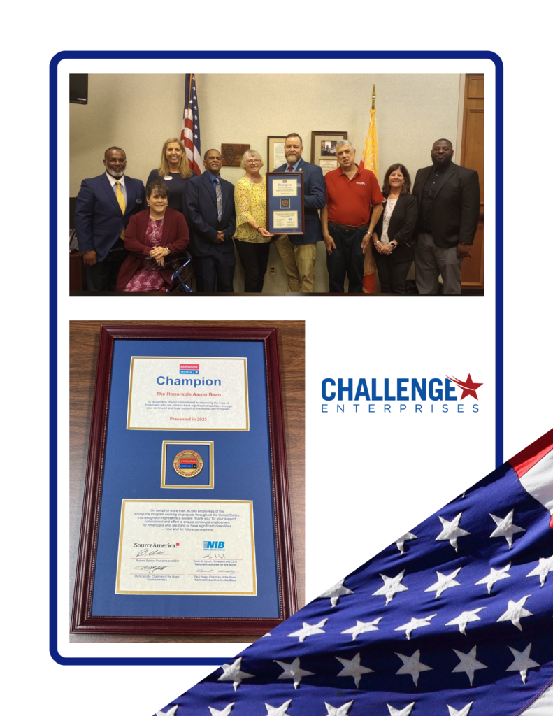 Image: Aaron Bean, holding the AbilityOne Champion Award, presented by staff members of Challenge Enterprises, a nonprofit organization supporting disability employment.